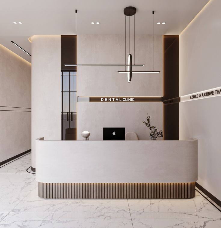 a white reception desk with a laptop on it