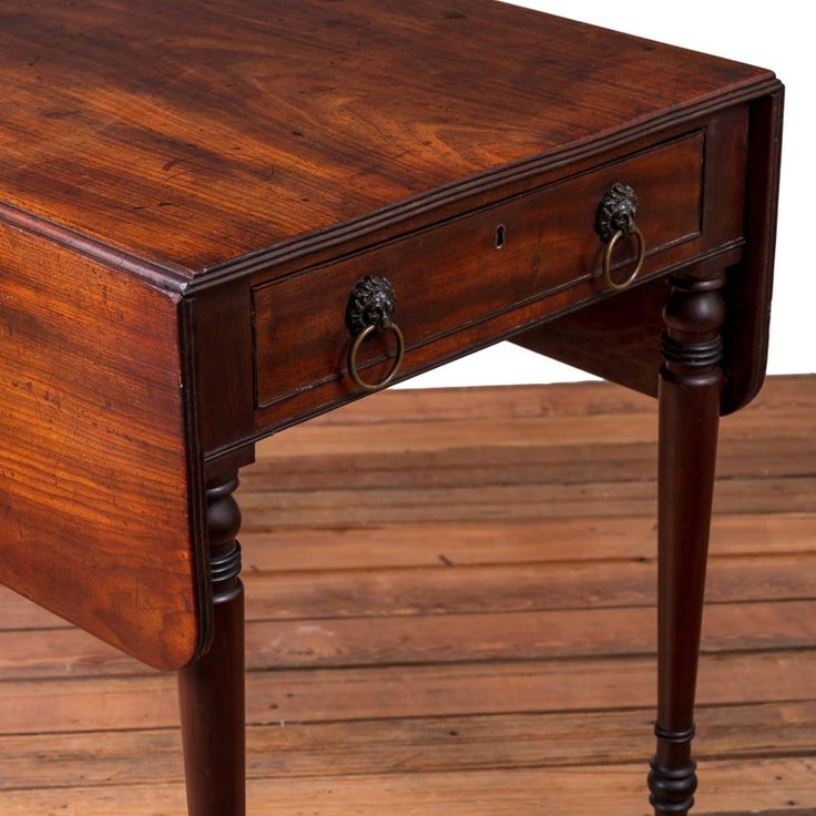 an old wooden table with two drawers on one side and a drawer on the other