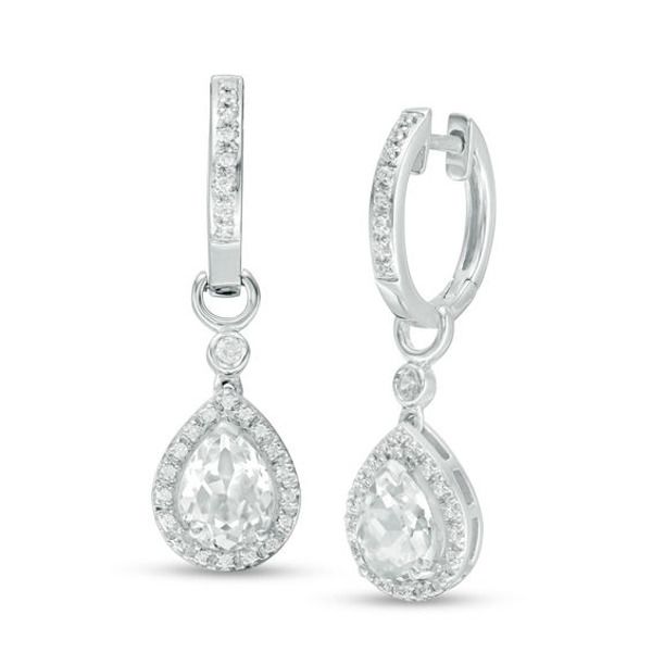 These exquisite diamond-touched drop earrings are a tantalizing look that doesn’t stop. Crafted in sterling silver, each earring glistens with a beautiful 8.0 x 6.0mm pear-shaped lab-created bright white sapphire outlined in glittering diamonds. A petite round bezel-set created sapphire accent and polished half-loop top the dangle, while additional created sapphires line the sculpted ear wire to complete this eye-catching style. Radiant with 1/5 ct. t.w. of diamonds and a brilliant buffed luster Diamond Frame, Peoples Jewellers, Diamond Glitter, Sapphire Stone, White Sapphire, Diamond Stone, Earring Backs, White Metal, Ear Wire