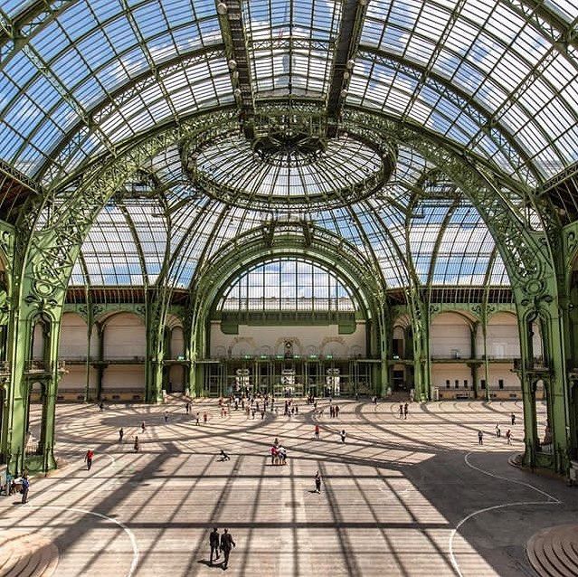 the inside of a building with many people in it