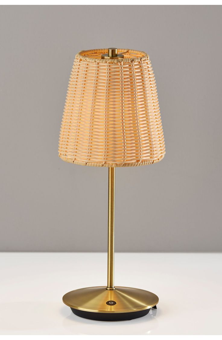 a lamp that is sitting on top of a white table with a yellow shade over it