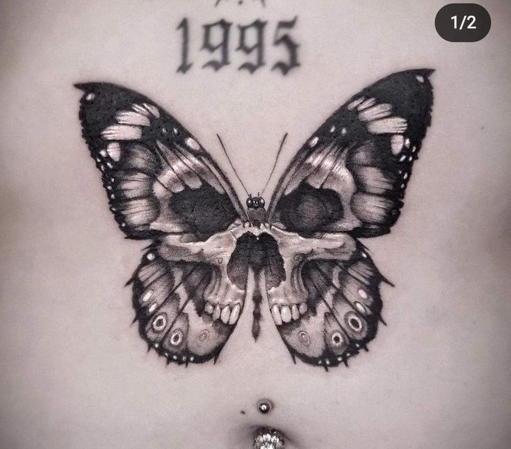 a black and white photo of a butterfly with the word tattoos on it's chest