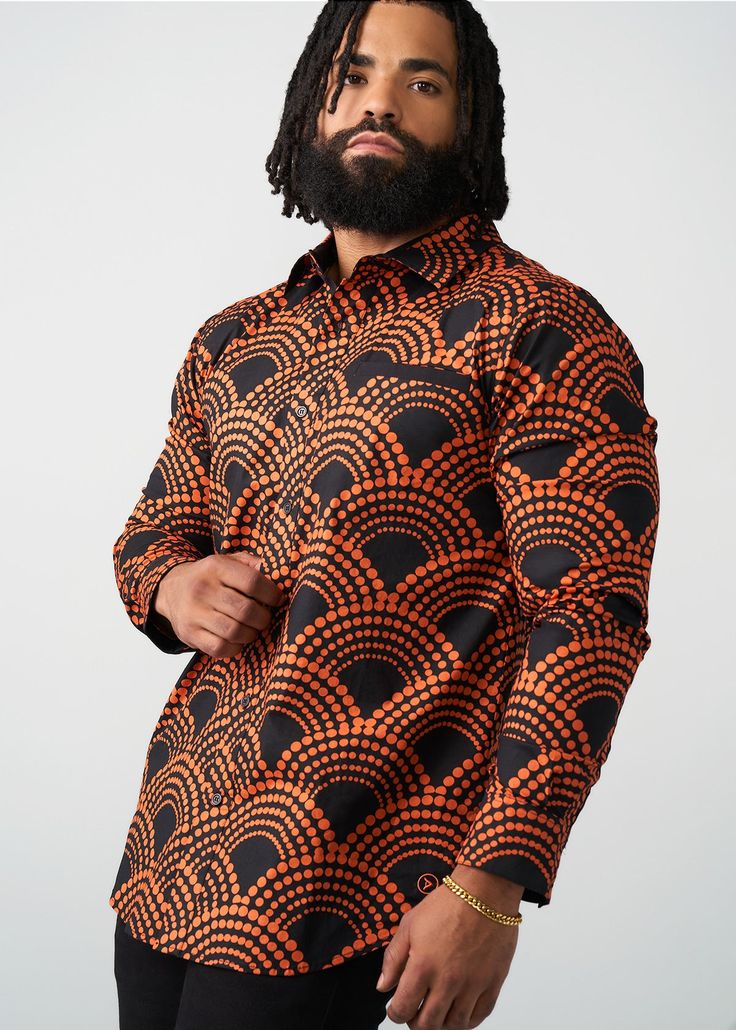 Style#: M2106 Meet the classic fall flannel's cousin, the Mazi Men's African Print Button-Up Shirt. The Black Amber Dots print gives all the fall vibes with an African twist. Features: Slightly rounded hem 97% Cotton/3% Lycra Stretch Poplin printed body, sleeves and patch pocket at chest 97% Cotton/3% Lycra Stretch Poplin Contrast Fabric at the Welt Pocket, Hidden Placket, and the Inner Sleeve Cuff Designed in the USA, imported Care Instructions: Machine wash cold on a gentle cycle with non-chlo Retro Black Shirt For Fall, Retro Black Long Sleeve Shirt, Fall Flannel, African Styles, Mens Fall, Sleeve Cuff, Workout Accessories, Printed Bags, Swimwear Accessories