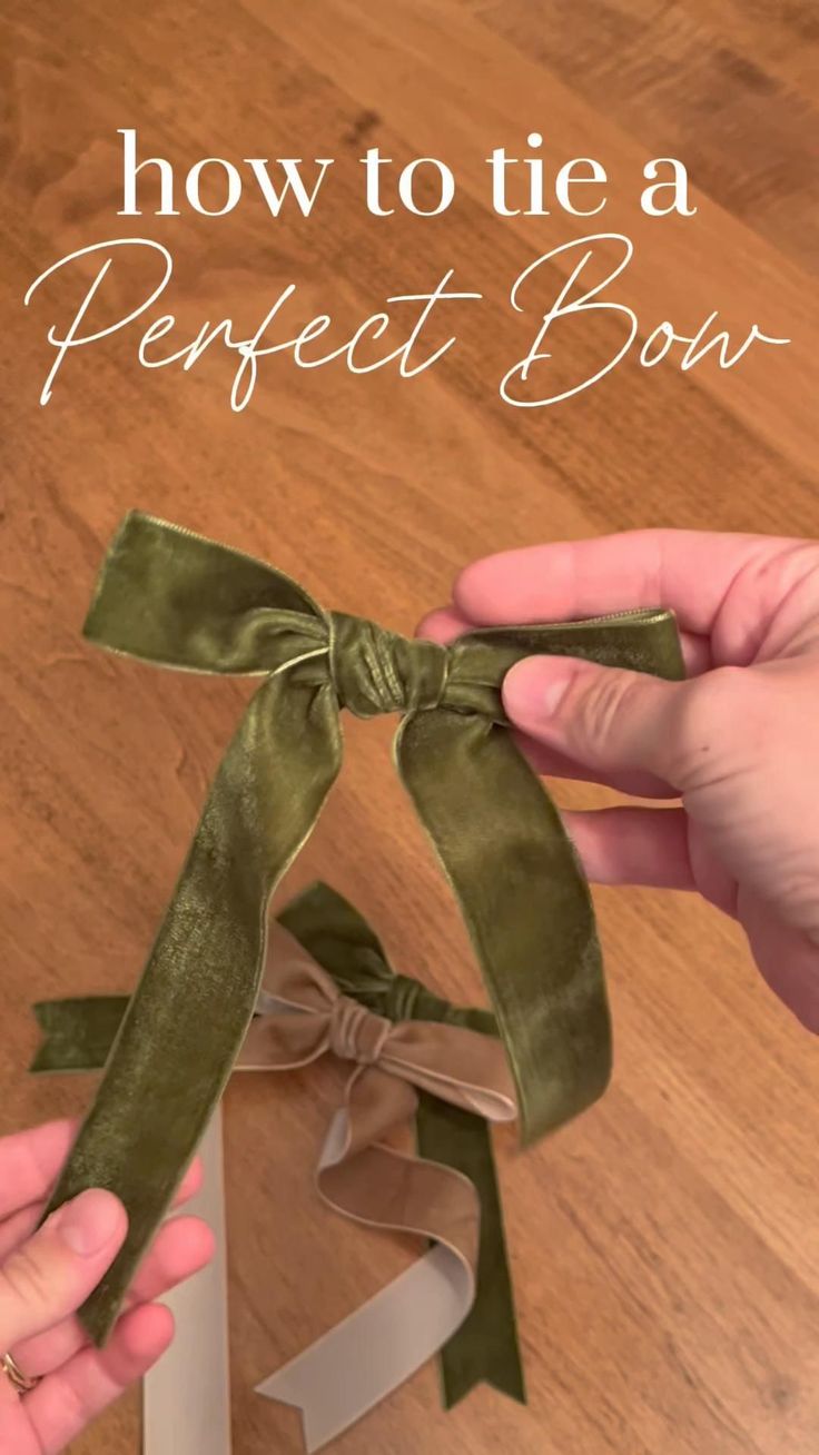 how to tie a perfect bow with ribbon on the end and two hands holding it