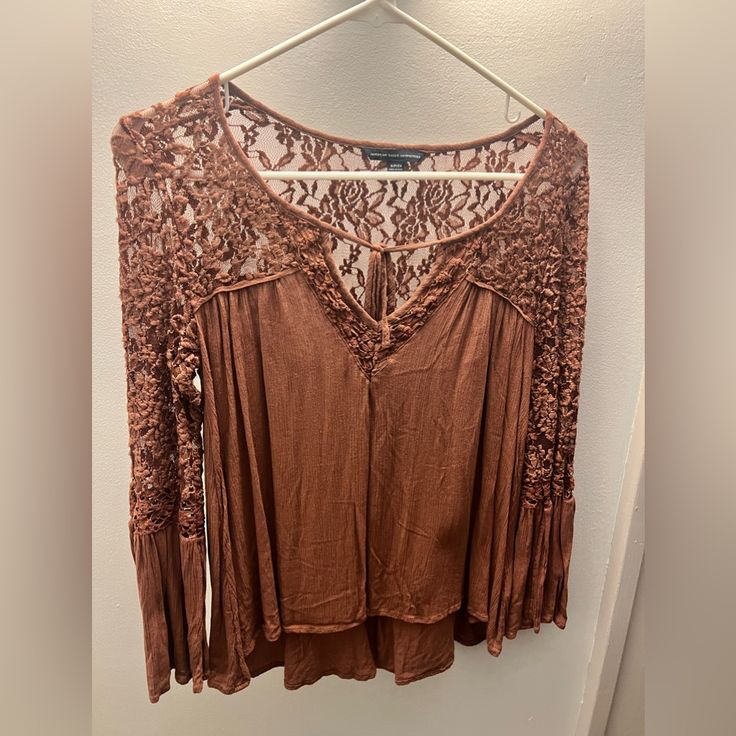 Never Worn!! Brand: American Eagle Color: Brown Lace Top With Front Tie Bell Flare Sleeve Size Small Soft And Comfortable!! Brown Fitted Lace Top, Fitted Brown Lace Top, Spring Brown Top With Lace Trim, Fitted Brown Top With Lace Trim, Fall Beige Lace Top Blouse, Beige Lace Trim Tops For Fall, Brown Lace Tops For Spring, Brown Lace Top, Ethiopian Opal Ring