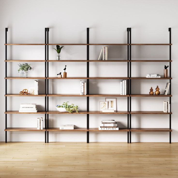 a bookshelf with many shelves and plants on top of it in an empty room