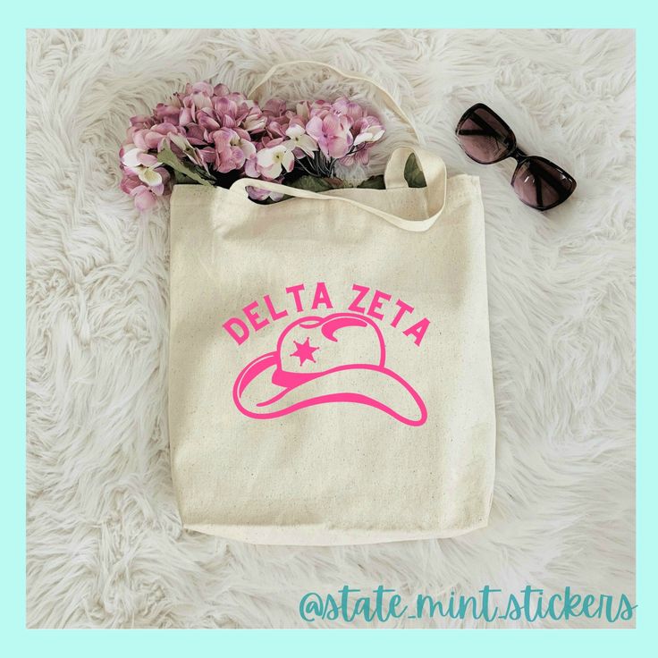 a tote bag with flowers and sunglasses sitting on a white furnishing area