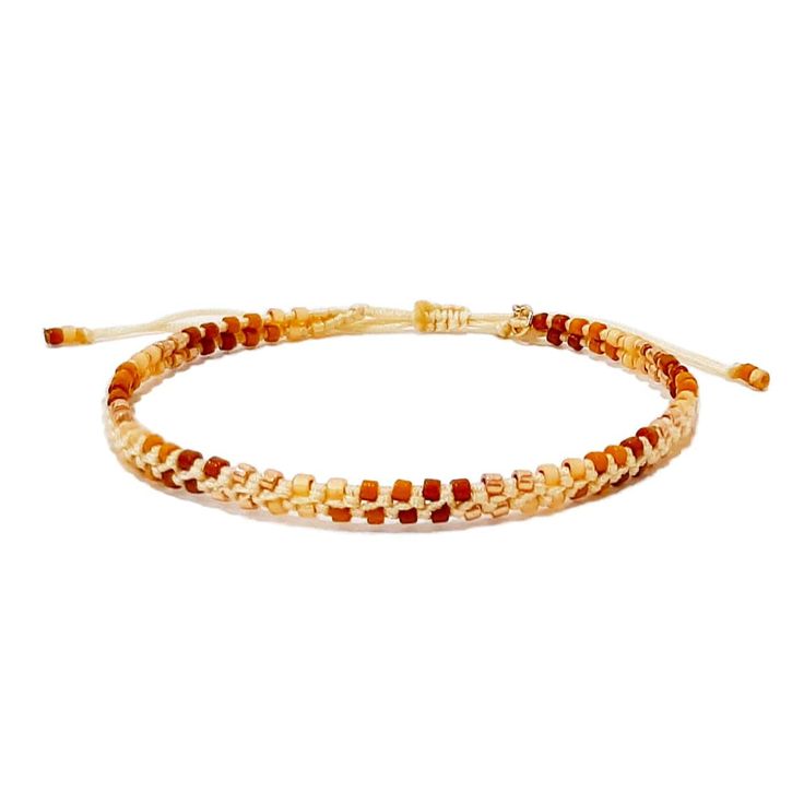 two stranded bracelets with orange and white beads on a white background, one beaded