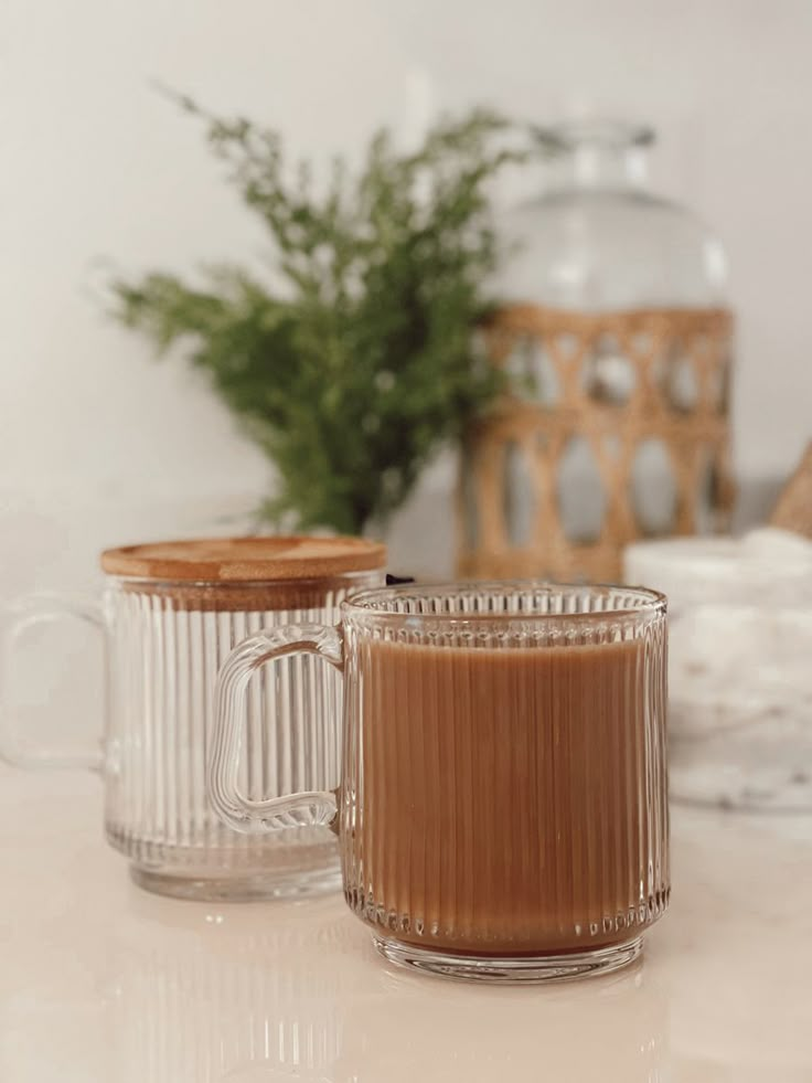 two glass mugs sitting on top of a counter