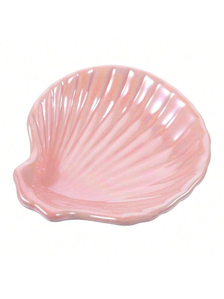 a pink shell shaped dish on a white background