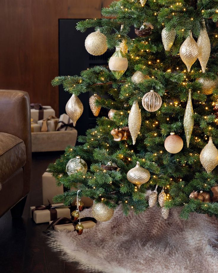 a christmas tree with gold and silver ornaments