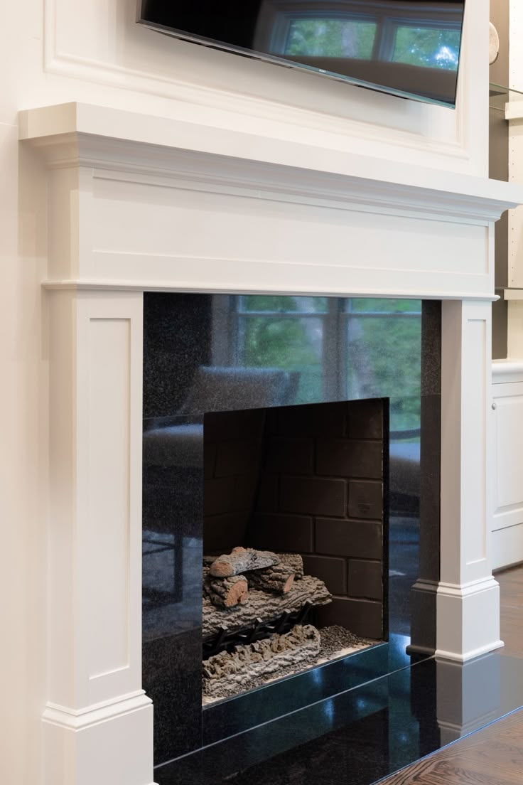 a fireplace with a flat screen tv above it