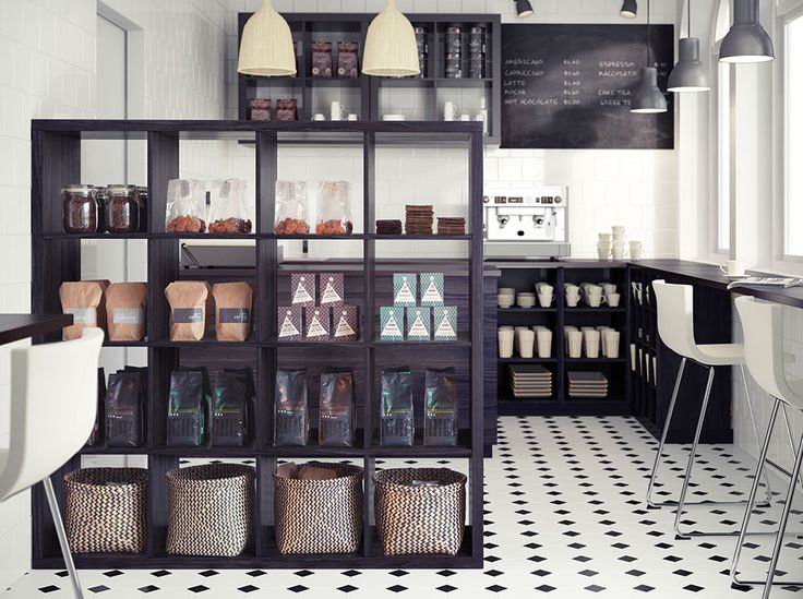 a black and white checkered floor with shelves filled with bottles, containers and chairs