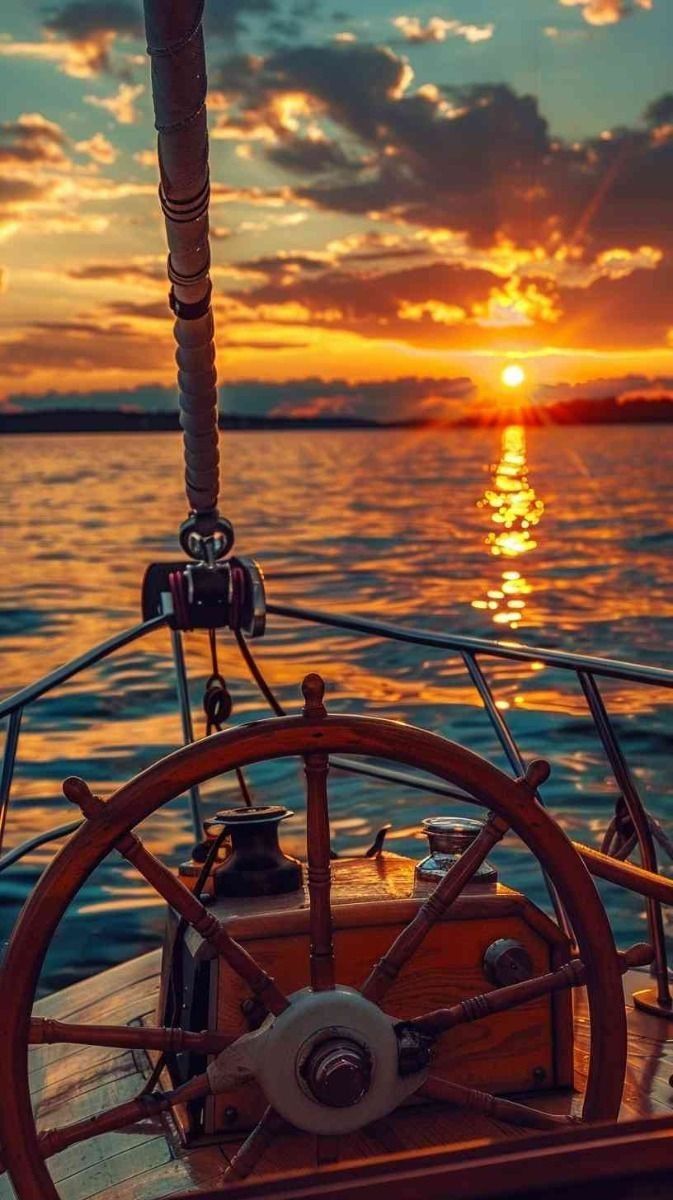 the sun is setting over the water on a boat