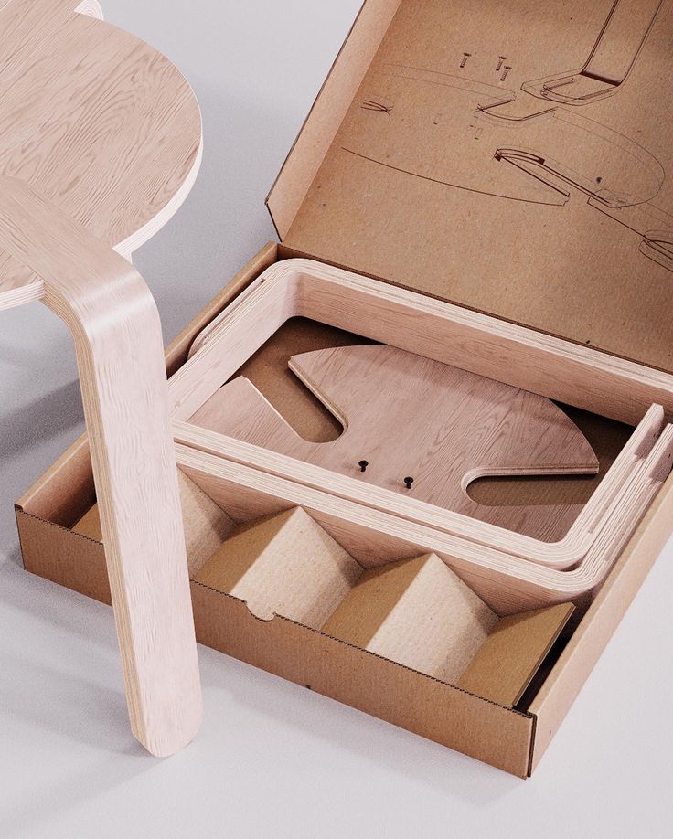 an open wooden box with tools in it on a white table next to a stool