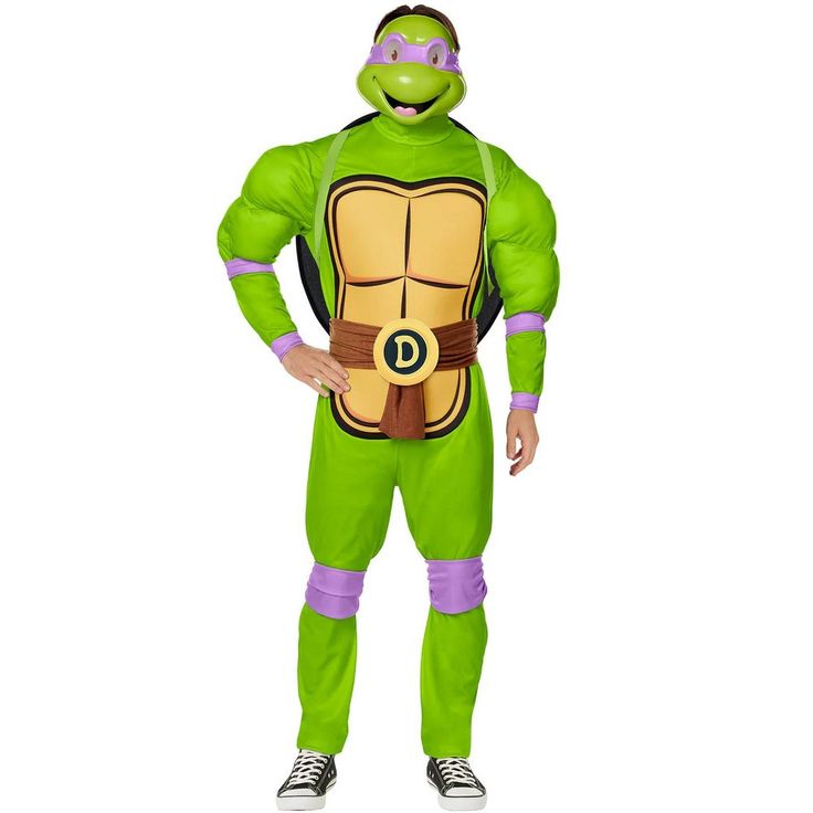 a man in a green turtle costume standing with his hands on his hips