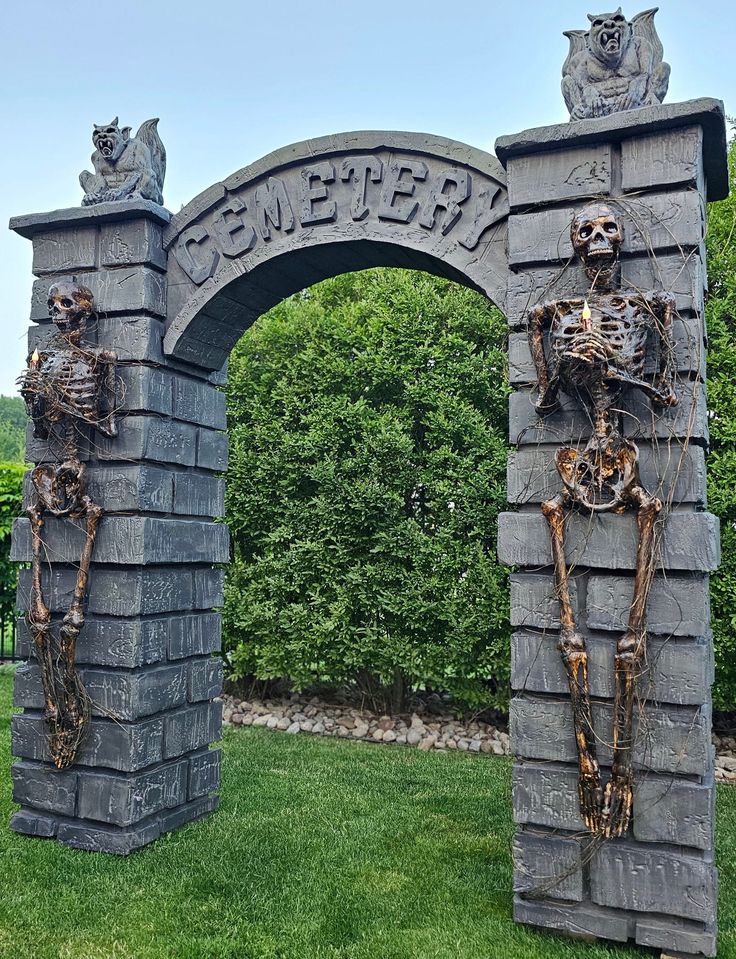 two skeletons are standing in front of a stone arch with the word cemetery written on it