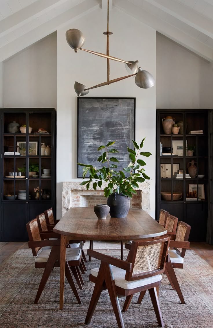 an image of a dining room table with chairs and potted plant on top of it