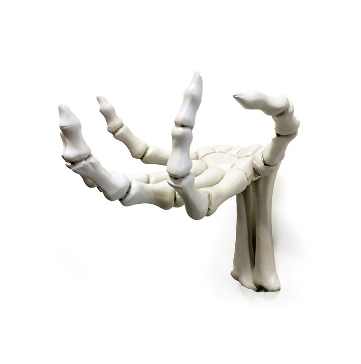 a white sculpture is sitting on the ground with its arms and legs spread out to form an x - ray