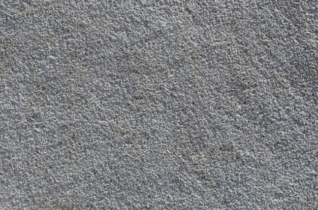 the texture of concrete is gray and has small patches of dirt on top of it