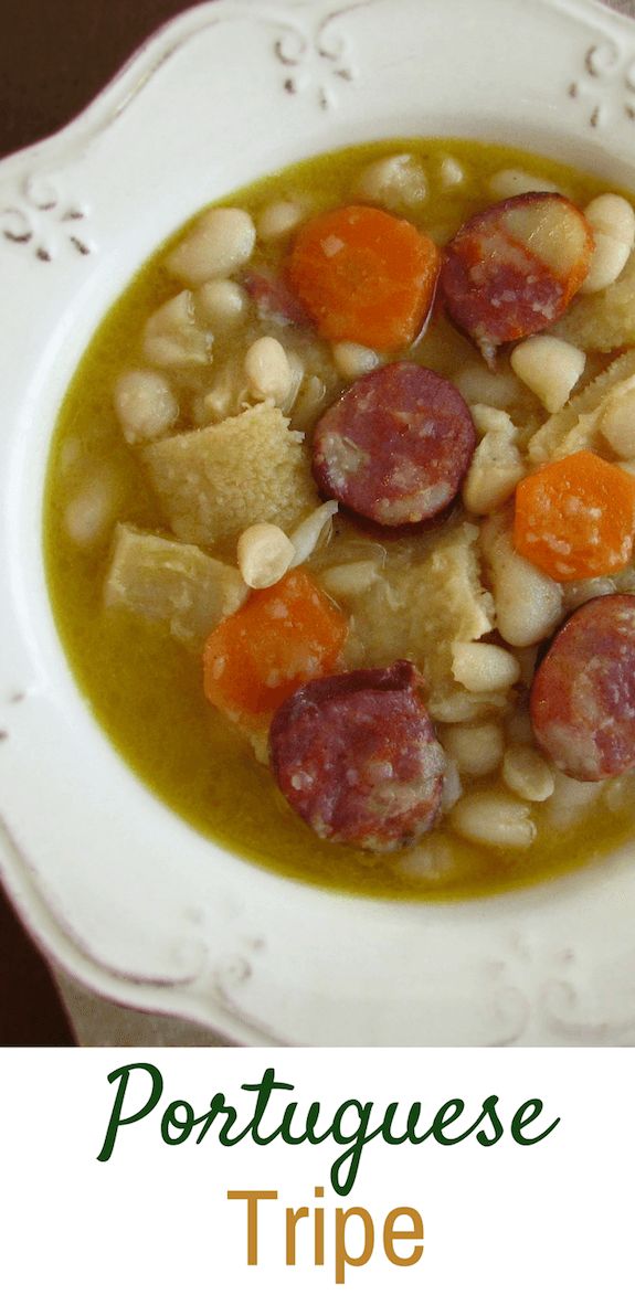 a white plate topped with beans and sausage