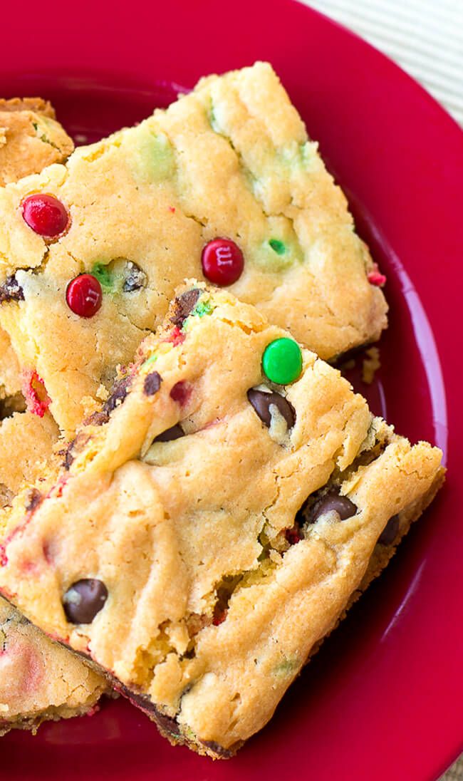 a red plate topped with cookies and candy bars