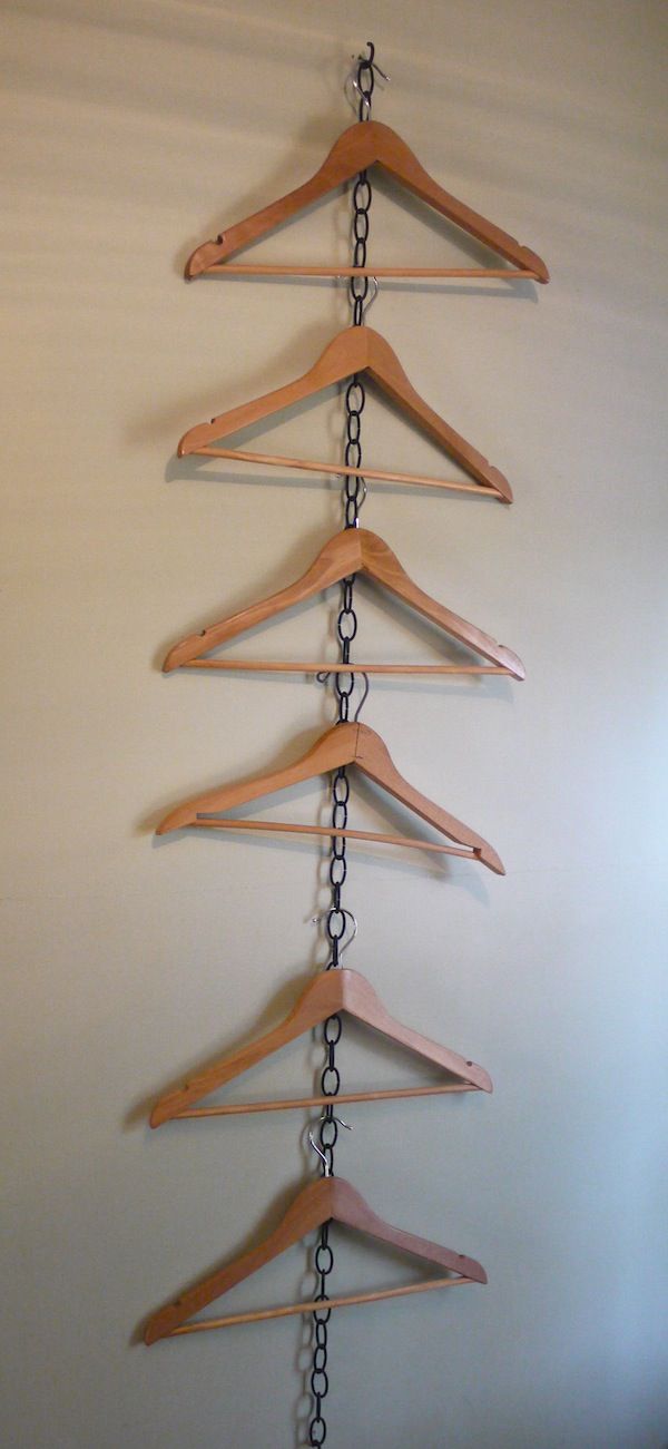 several wooden clothes hangers are hanging on a white wall and there is an instagram post about them