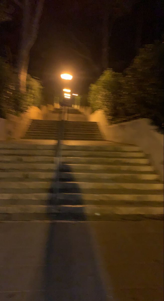 an image of stairs going up the hill at night with street lights on top and bottom