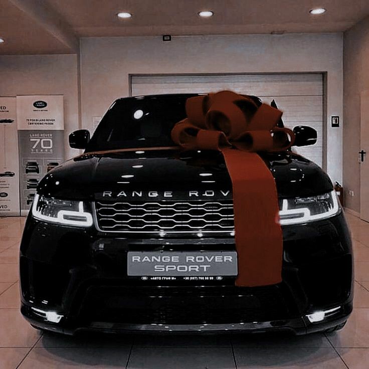 a range rover sports car with a large bow on it's hood