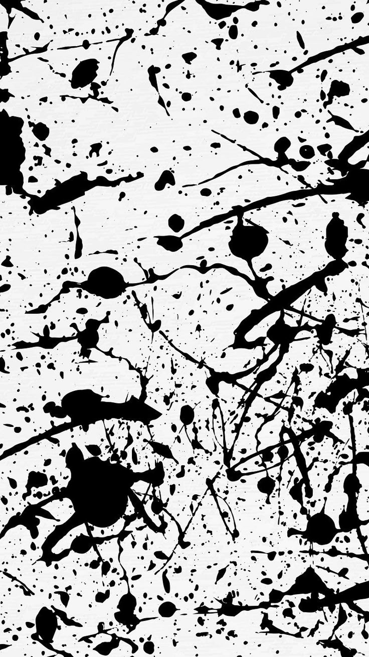 black and white paint splattered on the ground with lots of spots in it