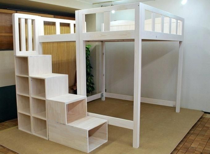 there is a loft bed with stairs in the room and shelves on the floor next to it