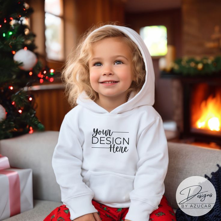 Introducing our baby toddler holiday sweatshirt mockup! A perfect mock for a diverse Christmas or New Years design, and more! Our mockup is ideal for Gildan 18500, Bella Canvas, Comfort colors 1567, or universal brands. Compliment your unique design this holiday season featuring this high quality digital mockup, showcasing an toddler / child modeling a white Hoodie Pullover Sweatshirt with Christmas backdrop. This mockup will help spread the holiday cheer in your Etsy shop while elevating your d Customizable White Hoodie For Gift, Customizable White Hoodie As Gift, White Hooded Sweatshirt Gift, New Years Design, Toddler Modeling, Holidays With Toddlers, Digital Mockup, Christmas Backdrop, Hoodie Mockup