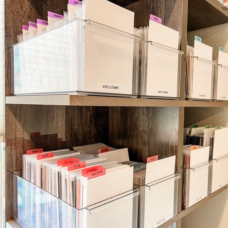 the shelves are filled with file folders and binder boxes for filing or records