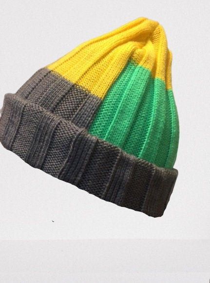 a multicolored knitted hat flying through the air