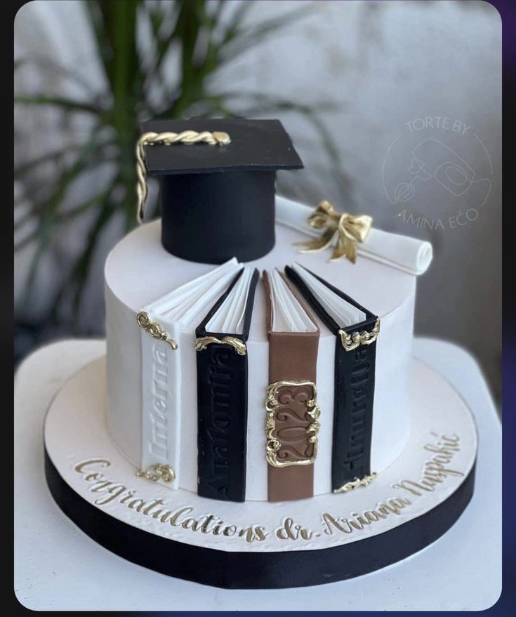 a cake decorated with books and graduation caps