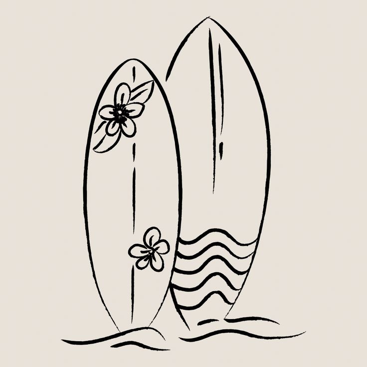 two surfboards sitting side by side in the water with flowers on them, one is black and white