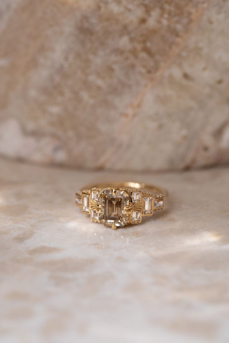 a gold ring sitting on top of a marble counter