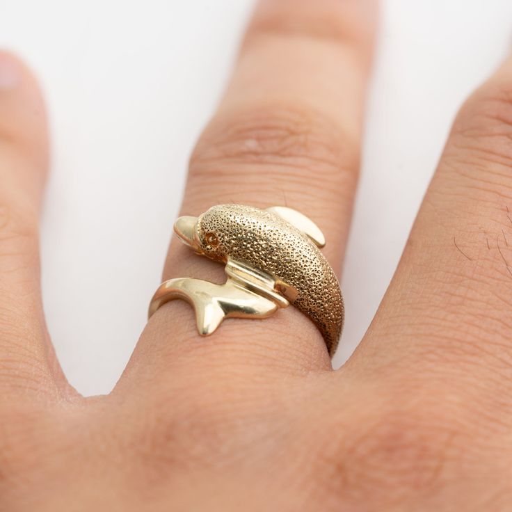 Hi. This is a very nice dolphin gold ring 14k yellow gold. It is marked 14k on the inside of the ring. The ring finger size is 7. Sorry, we do not resize rings. The gold ring weighs 4.3 grams. The top of the dolphin has some specular highlights. It's nice. Thank you very much for looking.