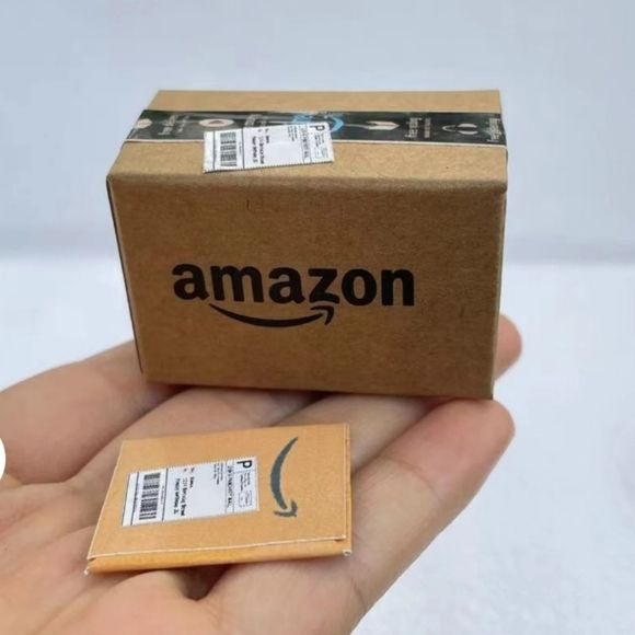 someone is holding an amazon box in their hand