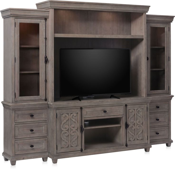 a large entertainment center with drawers and a flat screen tv