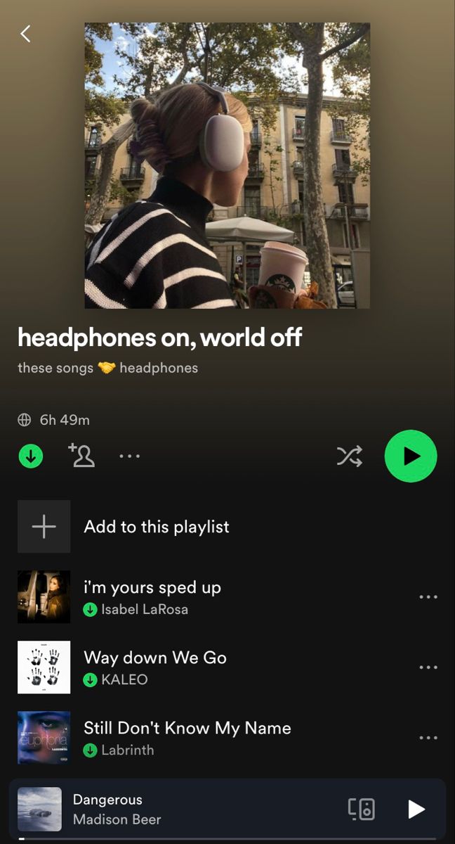 an iphone screen with the text headphones on, world off and music playlist