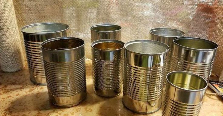 five tin cans sitting on top of a counter