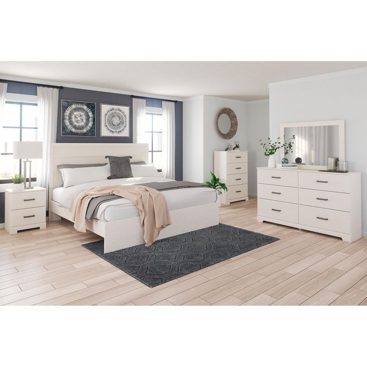 a bedroom with white furniture and blue walls