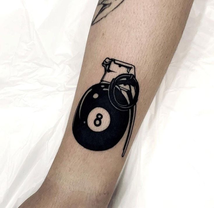 a tattoo on the leg of a person with a pool ball and cue in it