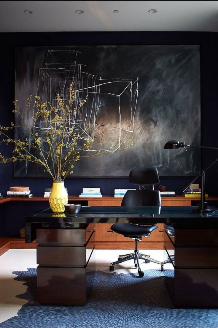 an office with a large painting on the wall