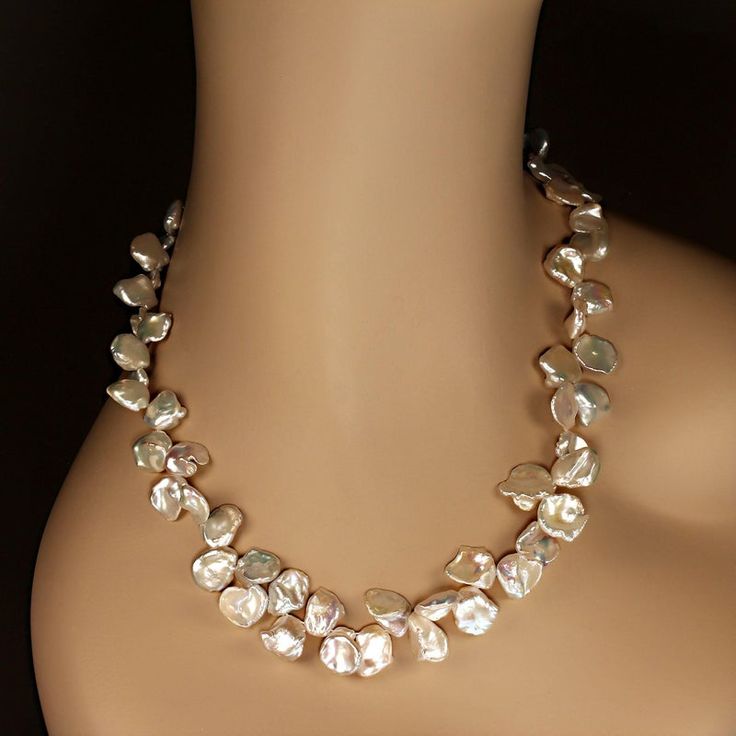 This is part of Chairish’s Fine Jewelry assortment.  Elegant 23-Inch Iridescent Keshi Pearl Necklace  This 23-inch necklace features exquisite white iridescent Keshi pearls, gently graduated in size from 9mm to 14mm. These uniquely shaped pearls, with their flat and rounded silhouettes, exude a luminous glow and captivating iridescence that effortlessly makes a statement.  Designed for both beauty and comfort, the necklace is secured with a versatile silver-plated toggle clasp featuring expandab Keshi Pearl Jewelry, Elegant Statement Necklace, Graduated Pearl Necklace, Japanese Pearls, White Pearl Jewelry, Keshi Pearl Necklace, Iridescent White, Iridescent Pearl, Kesha