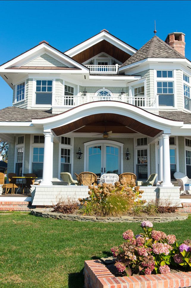 a large white house sitting on top of a lush green field