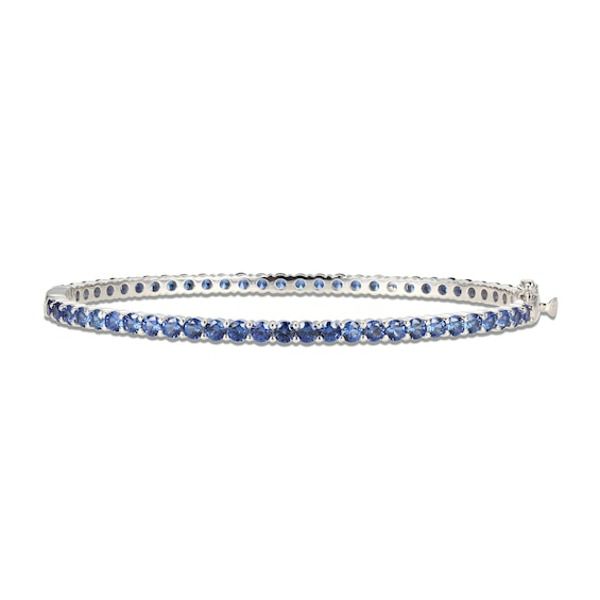 Gorgeous round blue lab-created sapphires adorn this sophisticated bangle fashioned in classic sterling silver. The bracelet measures 7.25 inches and secures with a box clasp. Timeless Blue Round Bracelets, Classic Sapphire Bracelet With Prong Setting, Classic Formal Bangle With Gemstone, Sapphire Tennis Bracelet With 17 Jewels, Classic Sapphire Tennis Bracelet With Prong Setting, Classic Sapphire Tennis Bracelet With Round Shape, Classic Round Sapphire Diamond Bracelet, Classic Sapphire Bracelets For Formal Occasions, Timeless Blue Bracelet For Formal Occasions