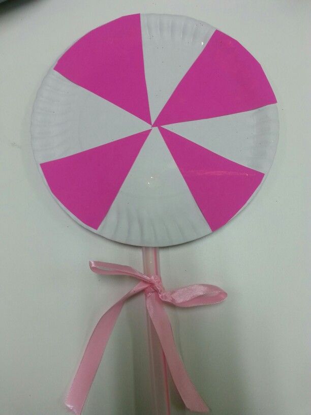 a paper plate with a pink and white umbrella on it