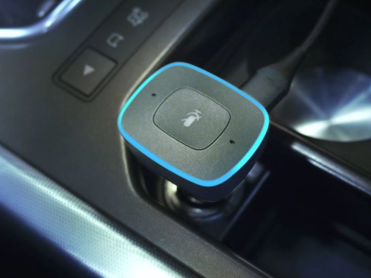 an apple device is plugged in to the car's center console and charging station